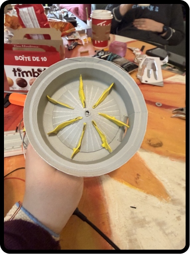 Close-up of the 3D-printed agitator disc with yellow foam paddle arms